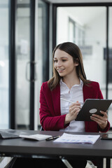 Happy excited young successful business woman and working online at the table in office, Businesswoman and finance marketing.