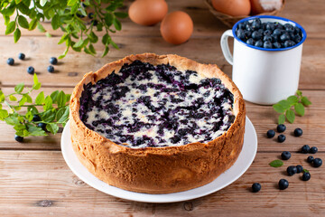 Blueberry pie and berries on wooden table