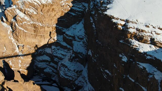 4K aerial view of Chicham bridge connecting Kibber and Chicham villages in Spiti Valley, India. Highest suspension bridge of Asia. 4,145 meters above sea. Travel and holiday concept.