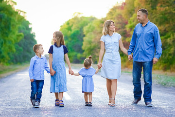 A Happy family walking along the road in the park on nature travel