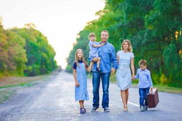 A Happy family walking along the road in the park on nature travel