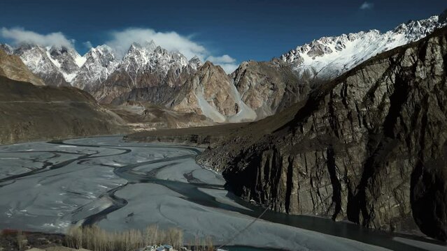 Aerial Pan shot of Passu Cones and Indus river in winters on sunny day. Aerial view of Hunza Valley