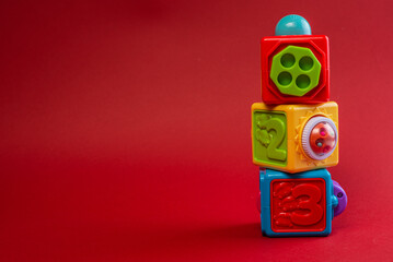 Obraz premium Color cube toy tower on red background.