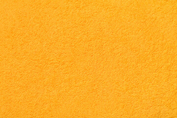 Yellow fluffy terry towel fabric texture surface or background.