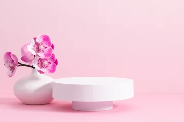 Deurstickers White round podium pedestal cosmetic beauty product goods branding design presentation empty mockup on light pink background with shadows and beautiful pink orchid flowers  cosmetic mockup © prime1001