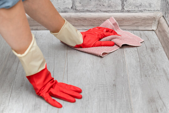 man in gloves doing wet cleaning of the floor