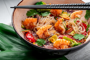 Rice noodles with shrimp and vegetables. Asian cuisine.