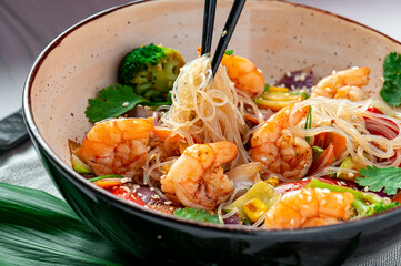 Rice noodles with shrimp and vegetables. Asian cuisine.