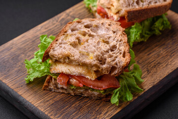 Delicious sandwich with crispy toast, chicken, tomatoes and lettuce