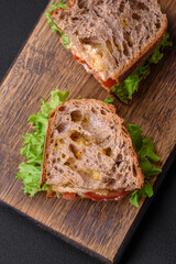 Delicious sandwich with crispy toast, chicken, tomatoes and lettuce