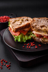 Delicious sandwich with crispy toast, chicken, tomatoes and lettuce