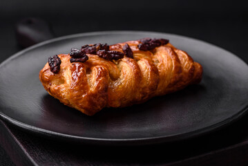 Delicious fresh baked pigtail bun with nuts and syrup