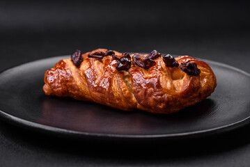 Delicious fresh baked pigtail bun with nuts and syrup