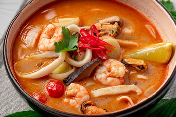 Spicy Asian tom yum soup with shrimp, squid, mussels and vegetables. Asian cuisine.
