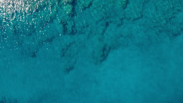 Background of crystal sea surface with turquoise water, Aerial top down view