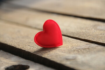 Obraz premium Red heart on a wooden background. Place for text. Valentine. Birthday background.
