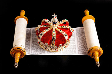 A Gold Coronation Crown with Red Velevet on a Bible on an Open Hebrew Scroll
