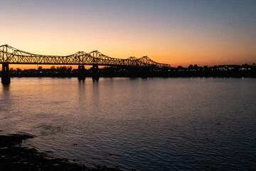 Sunset on the Mississippi River in Natchez, Mississippi with the Natchez Vidalia Bridge.