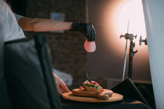 Professional shooting of food in advertising and cinema. Close-up. The work of a food stylist on the set.