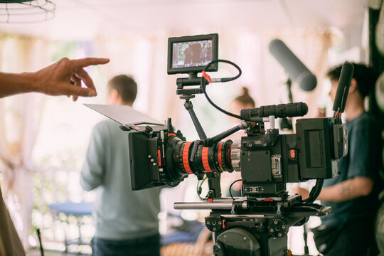 Professional cinema and video camera on the set. Shooting shift, lighting fixtures, shooting equipment and the team.