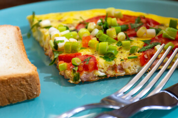 Breakfast omelette with tomatoes and green onions