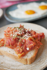 morning breakfast with tomato Scrambled eggs on a bread on white plate 