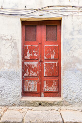 Peeling red paint on typical old wooden doors in Vila Nova de Gaia.