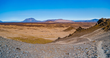 Fototapeta na wymiar Panoramic over a hiking trail at Icelandic landscape of colorful volcanic caldera Askja, in the middle of volcanic desert in Highlands, with red, turquoise volcano soil and blue sky, Iceland.