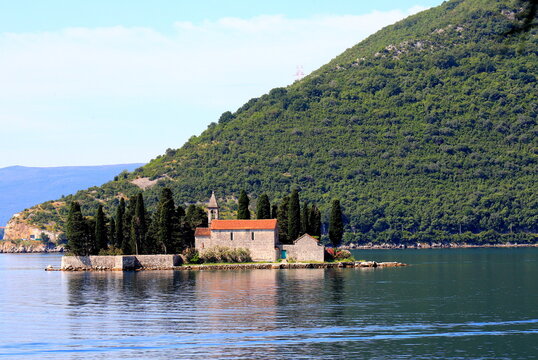 Island of St. George near town of Perast in Bay of Kotor, Montenegro. high mountains covered with green forest in Montenegro. Place for tourism, sports, leisure, hiking