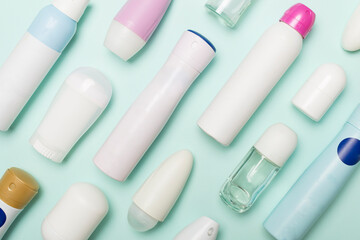 Many different deodorants on color background, top view