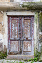 Peeling paint on an old wooden door.