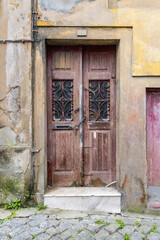 A wooden door on an old building in Portugal.