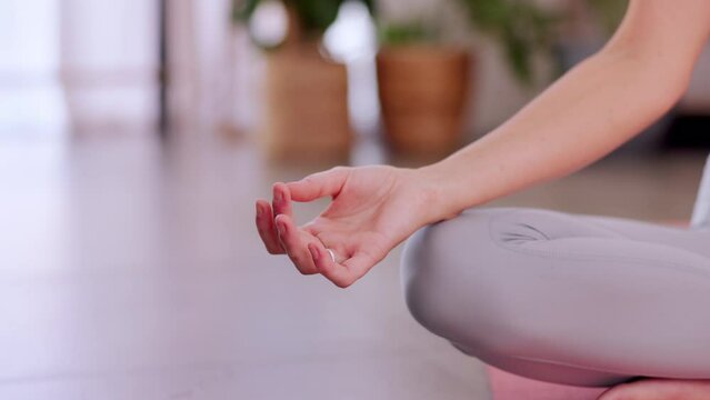 Woman, hands and yoga in meditation for zen workout, spiritual wellness or lotus pose at home. Hand of female yogi relaxing and meditating for awareness or mental wellbeing on mat in living room