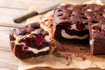 Homemade brownies with fresh berry on old wooden background