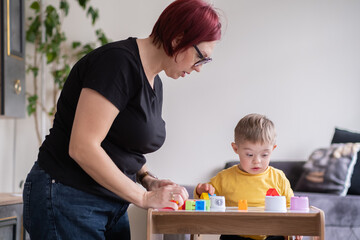 Family spending with educational toys, encouraging cognitive development child with Down syndrome