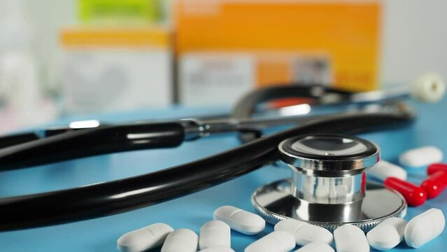 Medicines and a stethoscope. Capsules and tablets. Close-up.