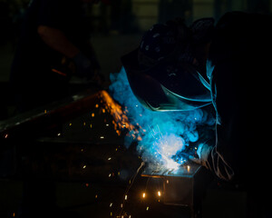 Tight photos of mig or wire welding. Smoke and sparks. - obrazy, fototapety, plakaty