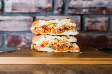 Cheesy Sub Sandwich isolated on wooden board top view on table fastfood