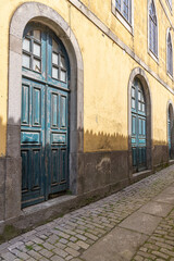 Arched doorways on a building along a narrow street in Caminha.