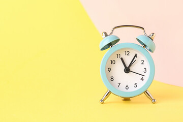 Alarm clock on color background
