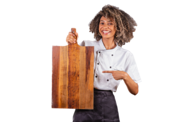 Young black Brazilian woman, cook, masterchef, wearing restaurant uniform. holding wooden board for texts and advertisements, presenting.