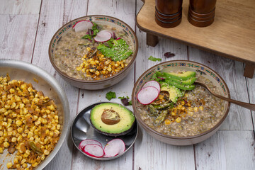Lentil and roasted corn  and tomato bowl,  avocado and sliced radishes