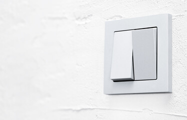 two-gang light switch on a gray wall close-up, side view