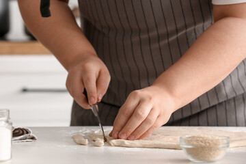 Fototapeta na wymiar Woman preparing Italian Grissini at table in kitchen, closeup