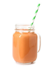 Mason jar of tasty orange smoothie with straw on white background
