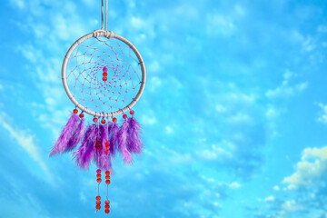 Beautiful dream catcher hanging against blue sky
