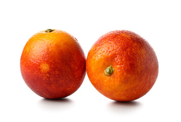 Whole tasty blood oranges on white background
