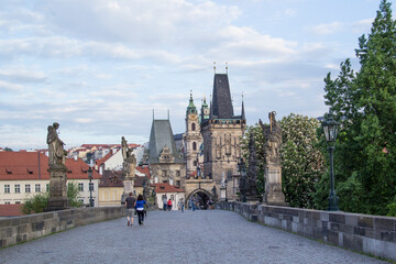 Beautiful view of the Malostranska tower of Charles Bridge at dawn in Prague, Czech Republic