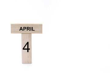 April 4 displayed wooden letter blocks on white background with space for print. Concept for calendar, reminder, date. 