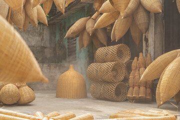 Weaving bamboo fish trap with basket in Hanoi, Vietnam.